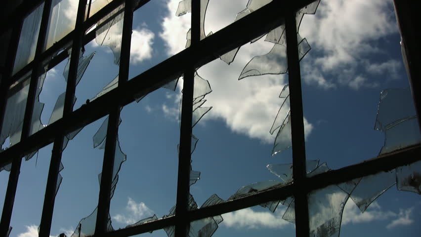 Broken factory window. Timelapse clouds.