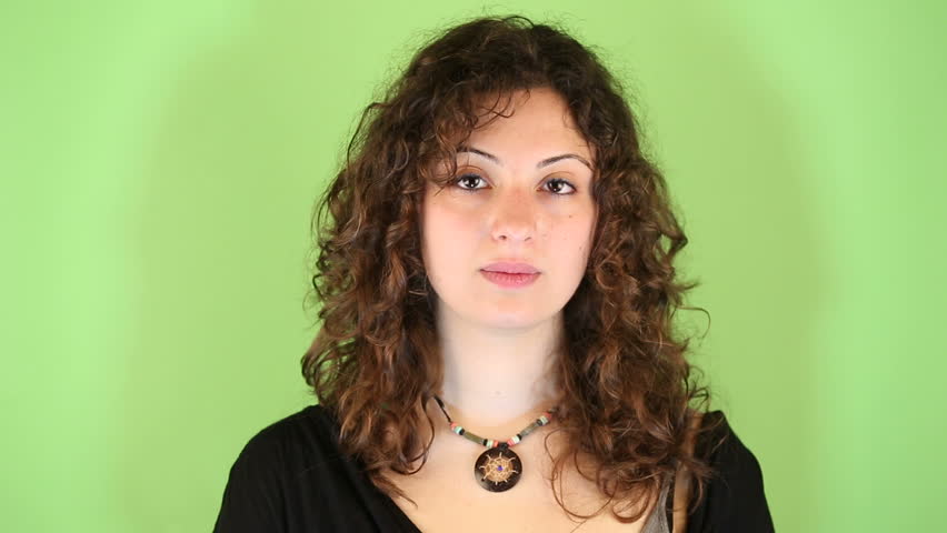 Young Woman Gesturing on Green Background