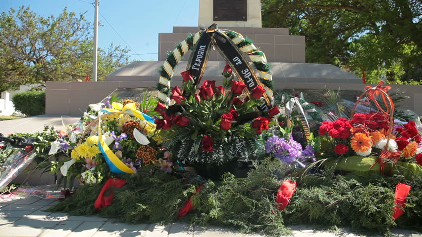 Remembrance wreaths and flowers on WW II war memorial