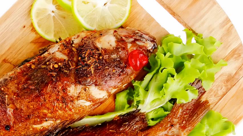 main portion of two grilled fish served on wooden plate 1920x1080 intro motion slow hidef hd