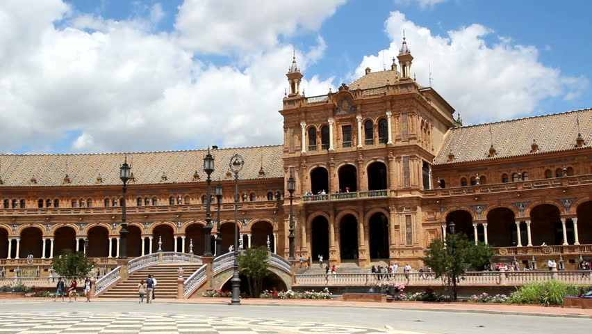 SEVILLE, SPAIN - MAY 15: Tourist in a horse carriage visiting the Plaza de Espana on May 15, 2013 in Seville, Spain. The Plaza de Espana was built in 1929 for the Ibero-American exposition.