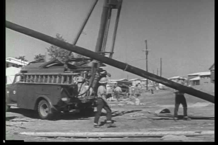 1940s - Archival black and white film describing construction of the nation's telephone system concentrating on the erection of telephone lines.