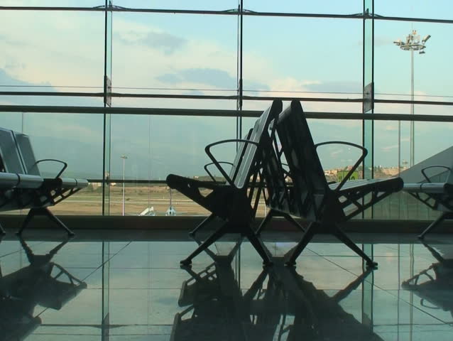 Seats reflecting in the floor of the airport lounge