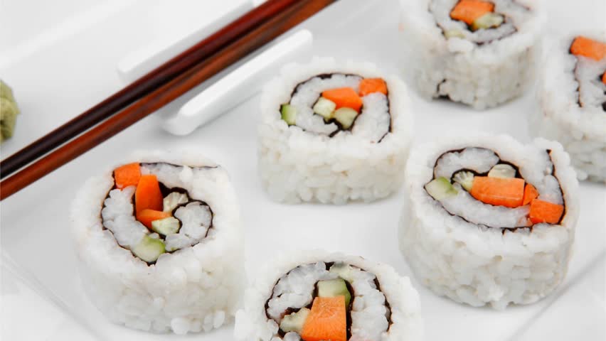Maki Sushi - California Maki Roll made of fresh raw Salmon Cream Cheese and Avocado inside. Served with wasabi . Isolated on square plate 1920x1080 intro motion slow hidef hd