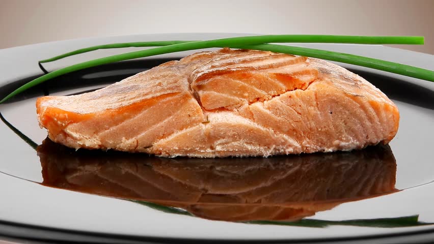 healthy fish cuisine : baked pink salmon steaks with green onion on black dish 1920x1080 intro motion slow hidef hd