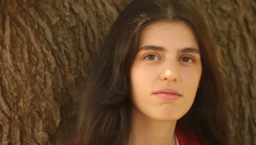 Outdoor portrait of happy brunette young adult woman.
