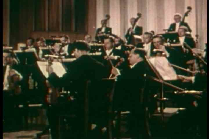 1950s - A conductor conducts a symphony orchestra.