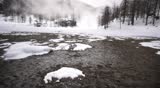 Aerial in mountains, snow close up fly over a frozen lake 