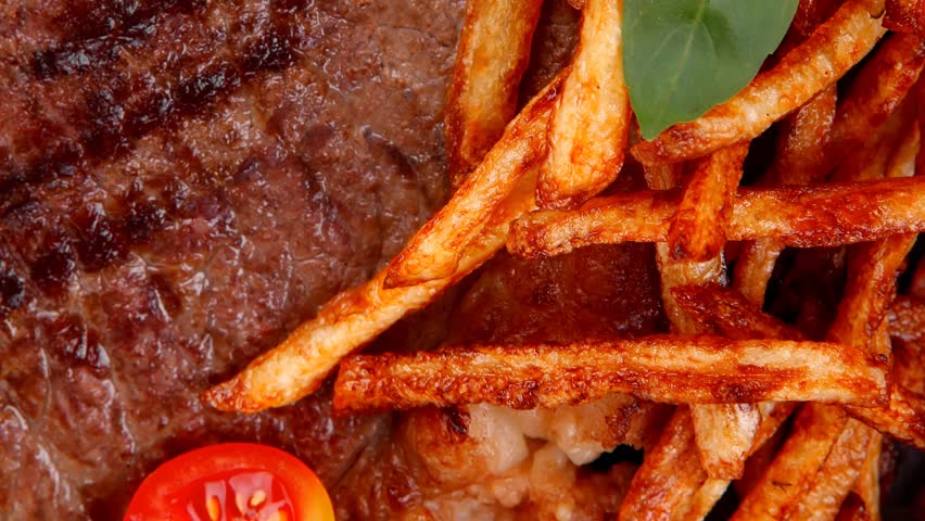 meat food : big grill beef steak on dark plate with red hot chili pepper and raw cherry tomato 1920x1080 intro motion slow hidef hd