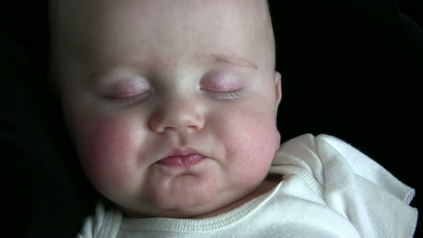 Baby begins to stir and wake up, then looks confused.  HD 1080i