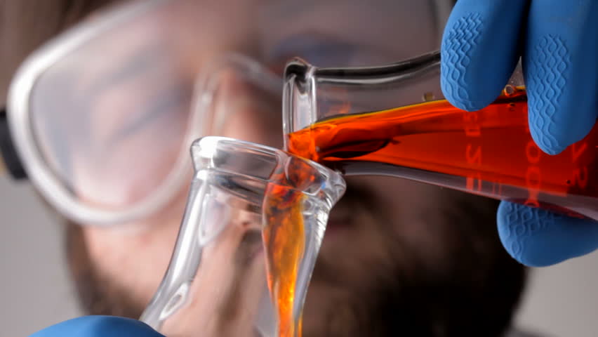 Scientist pouring biofuel  in lab