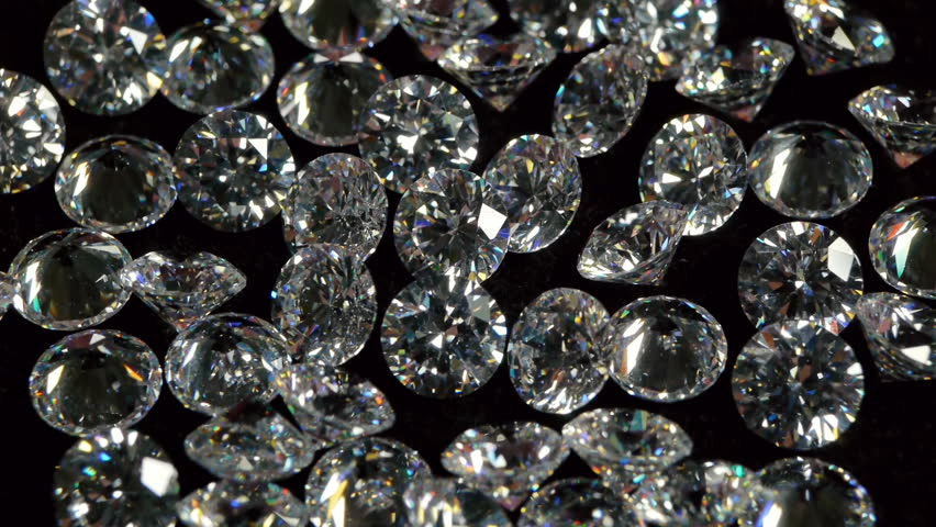 Selecting a Clear White Diamond With Pincers.