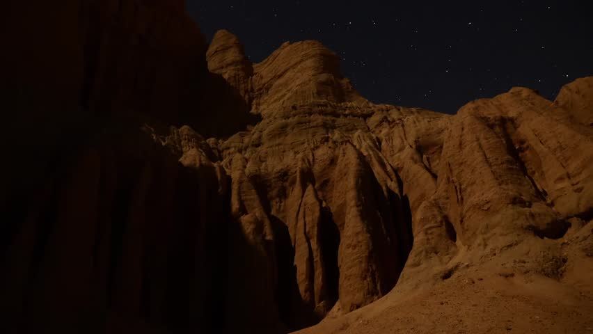Astrophotography Time Lapse Moonshadow across Sandstone Tilt Up