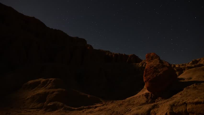 Astrophotography Time Lapse Moonshadow across Sandstone Tilt Up