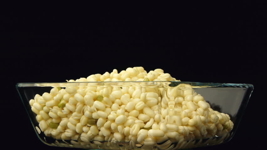  Mung bean sprouts in a transparent bowl on a black background