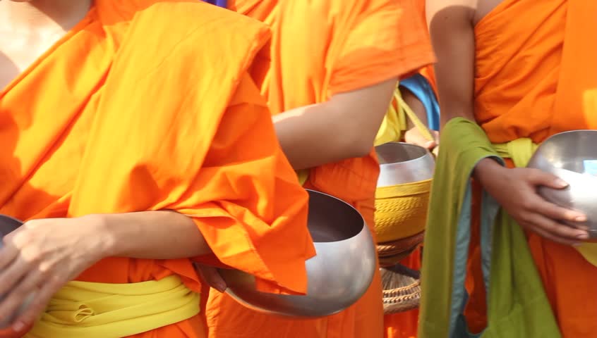 Giving food and drink offerings to Buddhist Monks Of Thailand 