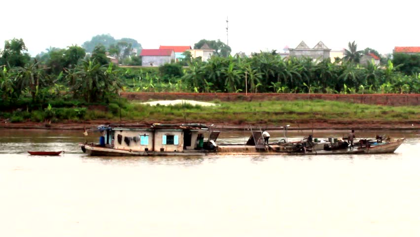sand dredgers in the riverbed