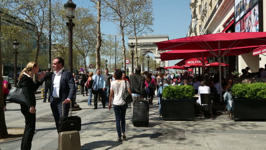 PARIS - APRIL 26: Unidentified people in Champs-Elysees walk past cafes and restaurants on April 26, 2013 in Paris. Champs Elysees and Arc de Triomphe are major tourist attractions.