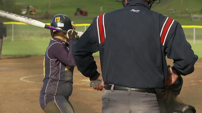 batter hits ball in softball game