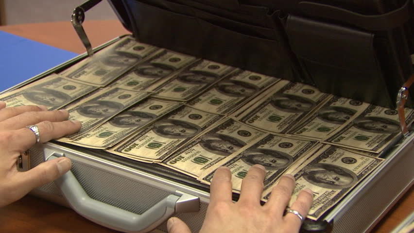 Attached Cases Filled with Money. Bonus: 3 shots in 1. First shot: two attached silver cases full with dollars; Second: Close up of the bills; Third: a bill is getting pulled out.