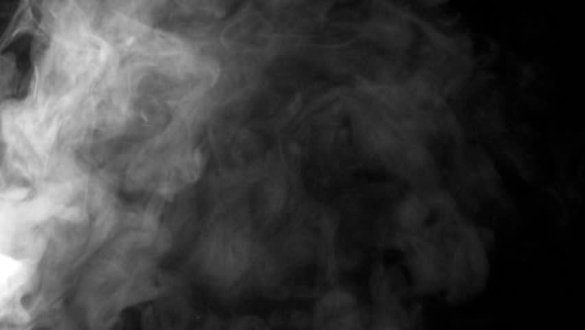 Smoke billowing over a black background.