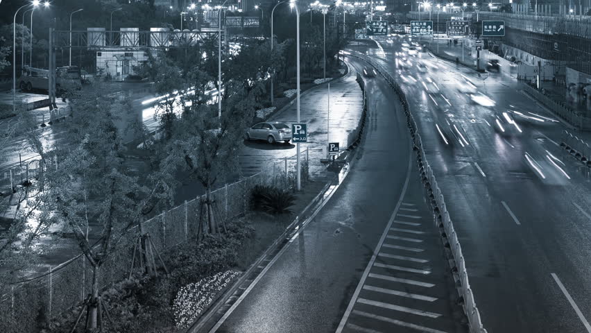 Wide time-lapse shot of cars at night in an urban landscape