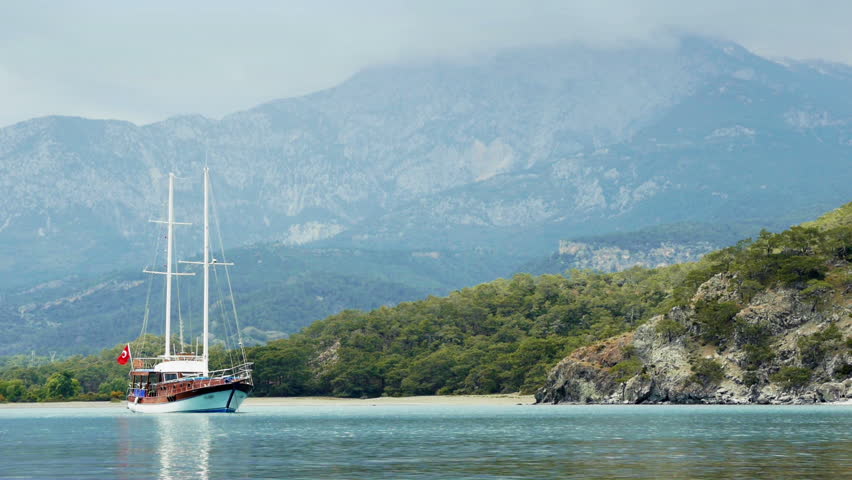 Touristic ship moored near the shore of  ancient Greek and Roman city Phaselis, Turkey