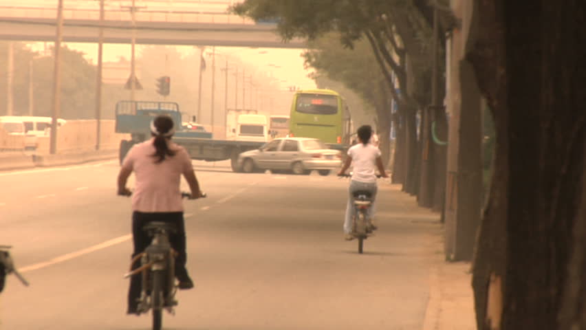 Vehicle traffic in Beijing, China including cars, motorcycles, trucks, buses and bicycles