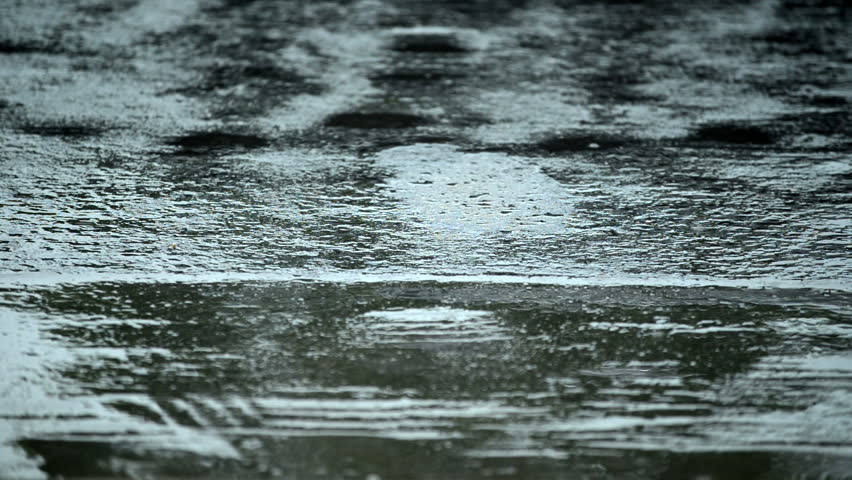 Rain drops falling on the road 