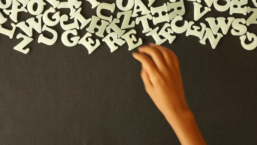 A person spelling Please Donate with Plastic Letters (In German)