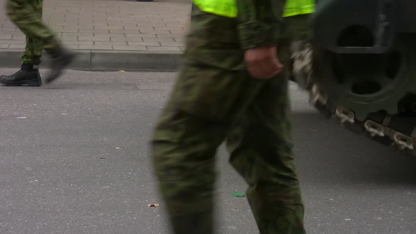 Closeup of moving continuous tracks of tank on a military parade in the city