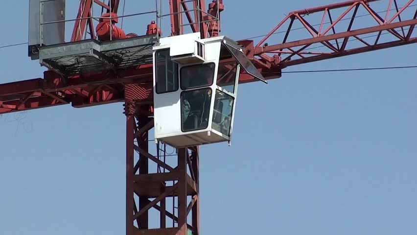 Construction crane working, zoom out
