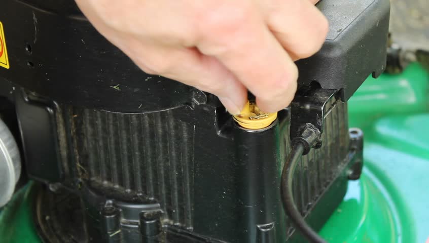 checking the oil on a small push lawnmower