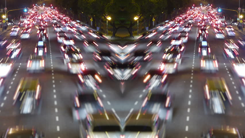 Traffic in the city. Avenue Time-Lapse, symmetric / mirrored, Night. Moon going down. Heavy traffic / jam / flowing with blurred motion.