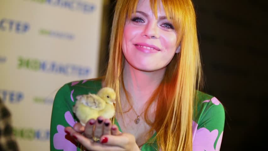 MOSCOW - JUNE 5: Anastasia Stotskaya (Russian-Ukrainian pop singer and actress) holds chick at presentation of Lena Lenina Stars in style of ECO in restaurant MUZEY on June 5, 2012 in Moscow, Russia.