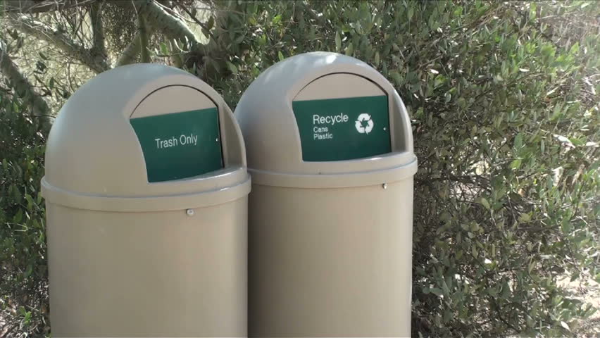 1920x1080 Man drops plastic bottle into recycling bin.