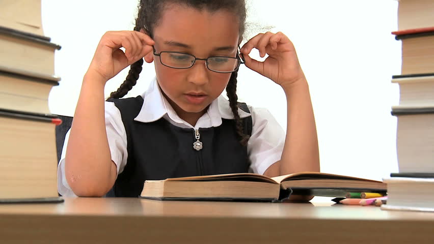 Cute african american schoolgirl early learning with reading books