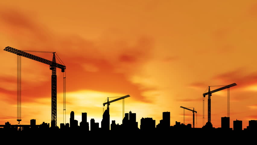 Time lapse of construction at sunset with city in the background