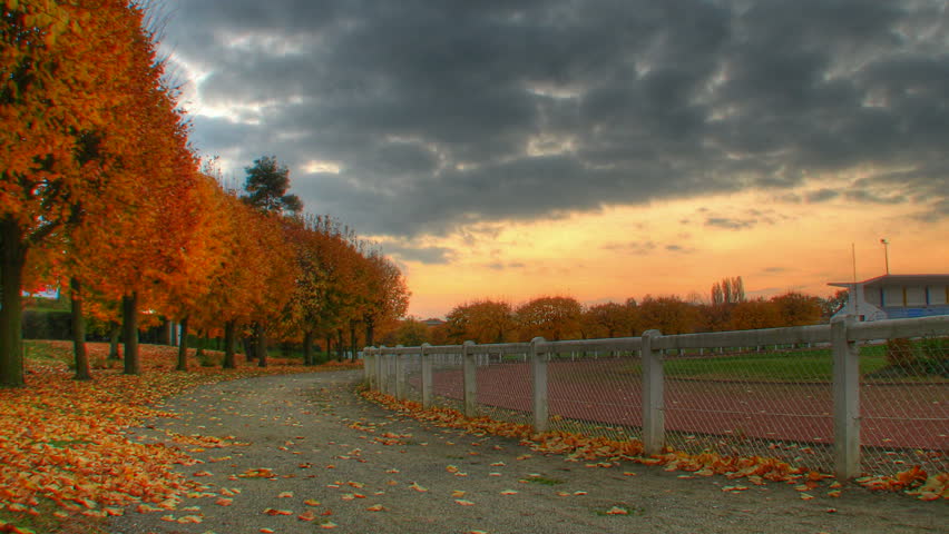Autumn sunset over trees at stadium, HD motorized time lapse clip, high dynamic range imaging
