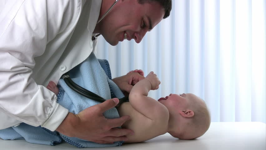 Male doctor listens to a baby's lungs using a stethoscope