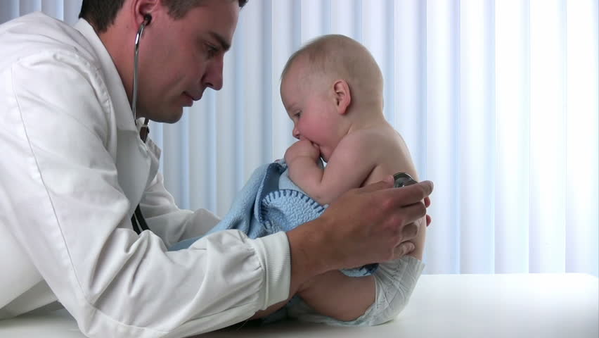 Male doctor listens to a babyÃÂ¢??s lungs using a stethoscope