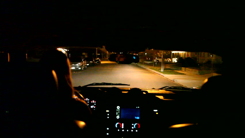Timelapse of a Woman Driving Through the City at Night