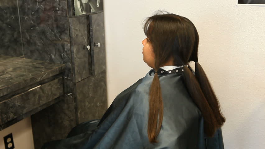 Hispanic Woman Cutting and Donating Her Hair to Charity