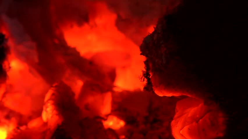 Glowing, blazing wood embers of a dying fire. Narrow depth of field and extreme Close-up. Clip Two