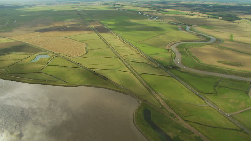 Flyover of road and rail link with large expanse of salt water and fresh water river
