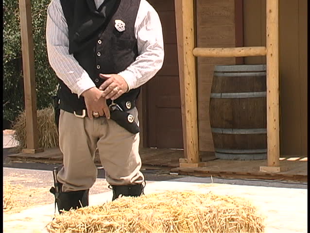 A "gunfighter" in a fast draw competition draws and fires his pistol - in slow motion