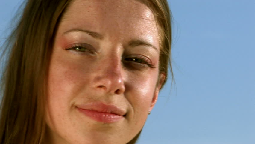 young woman smiling on a background of sky HD