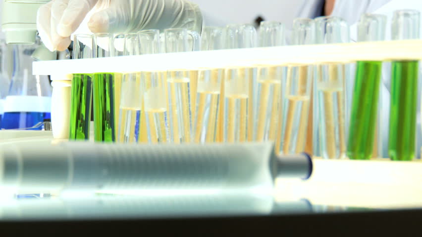 Close up of female scientist examines a test tube