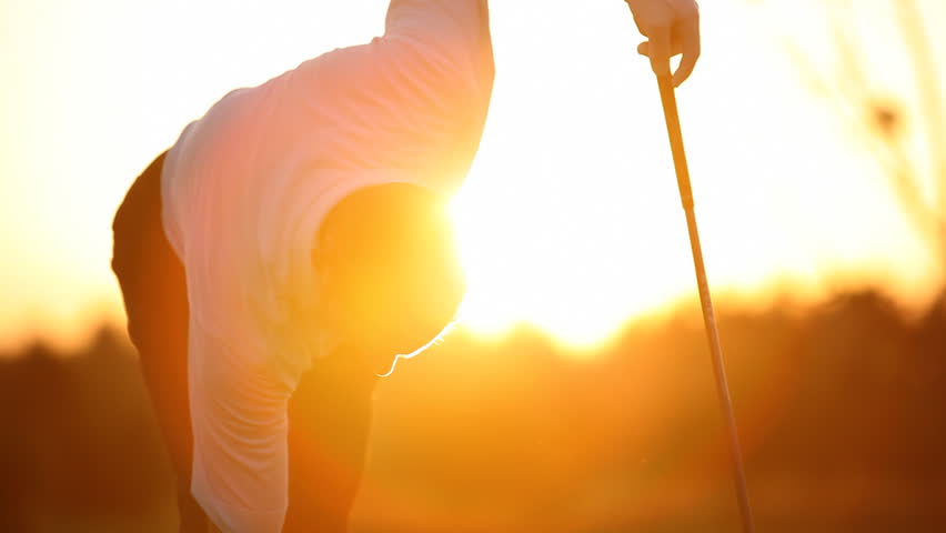 Golf player preparing to tee off