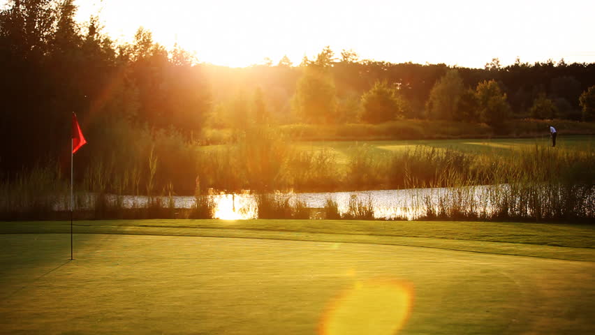 Golf player teeing off on beautiful golf course